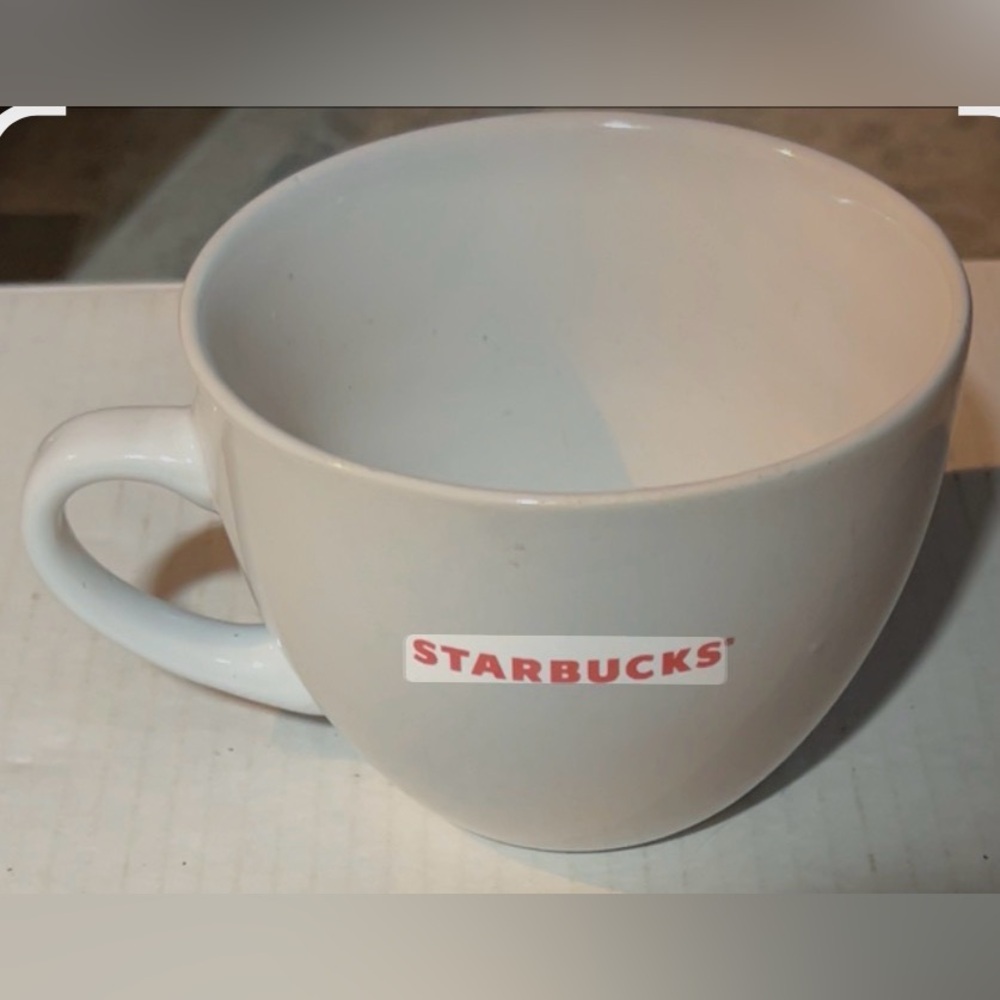 White Starbucks ceramic coffee mug featuring red lettering, 2008.